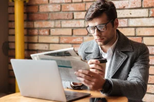serious-businessman-eyeglasses-sitting-by-table